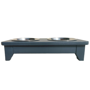 Handmade wooden raised double dog bowl with two metal bowls on a white background painted in farrow and ball Hague Blue