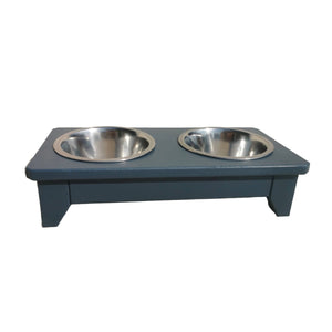 Handmade wooden raised double dog bowl with two metal bowls on a white background painted in farrow and ball Hague Blue